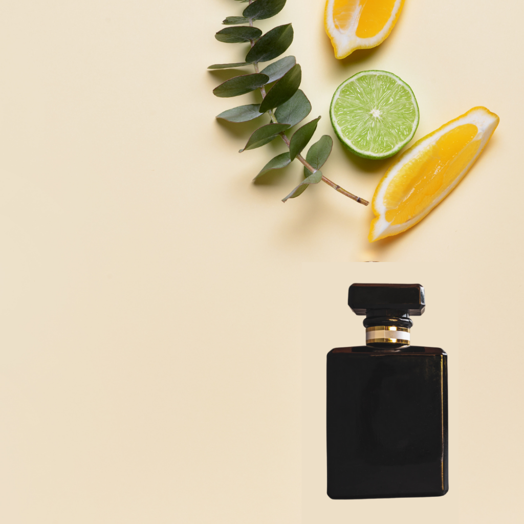 Citrusfrugter og parfumeflaske liggende på et bord